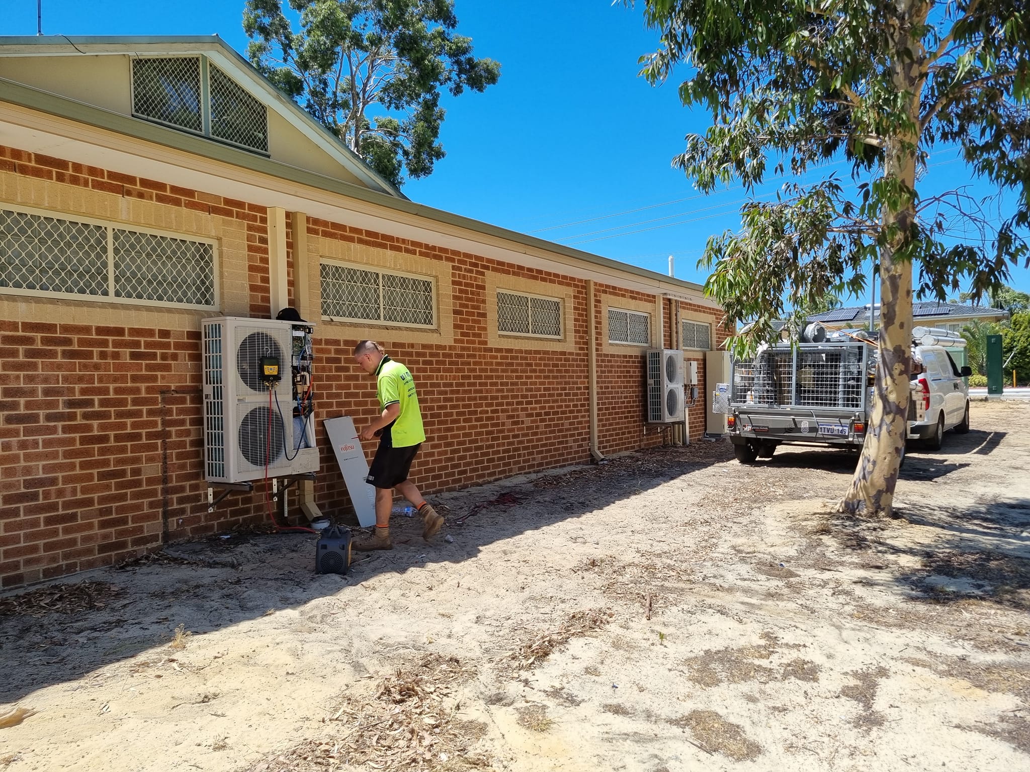 Perth Solar and Air technician working on air conditioning equipment